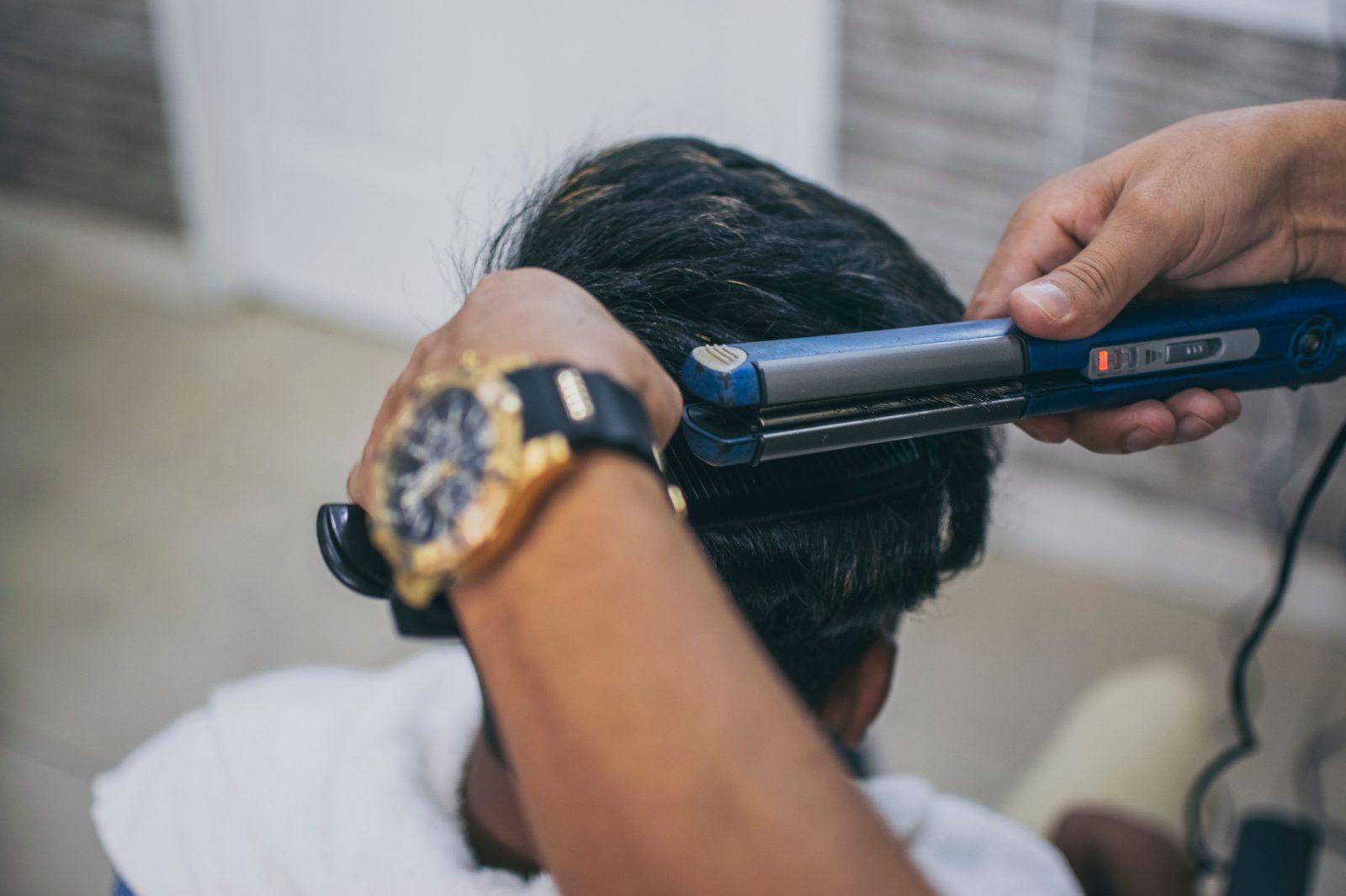 A hairstylist working on a client